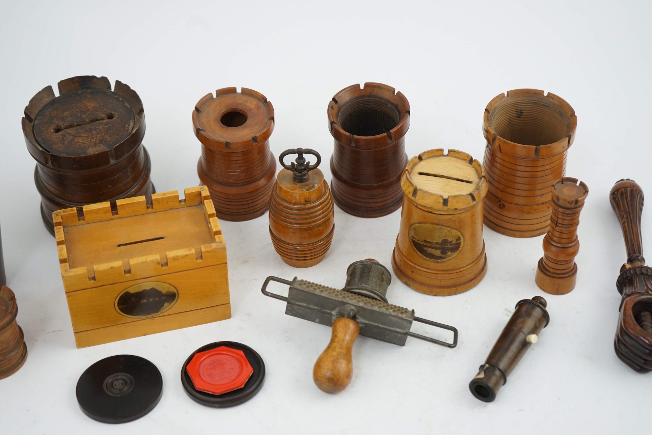 A collection of Victorian and Edwardian treen comprising castellated boxes, nutcrackers, kitchenalia and a glass holder. Condition - fair to good